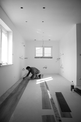 Flooring professional installing luxury vinyl plank flooring